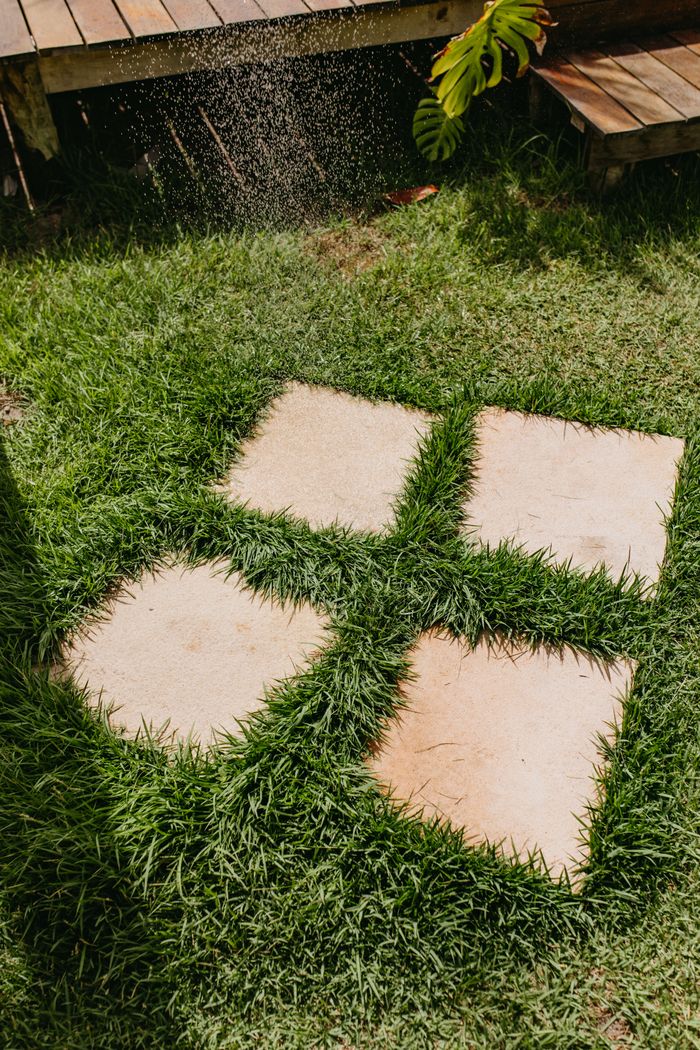 About Charming garden patio with stone tiles amidst lush green grass, captured in Bahia, Brazil.